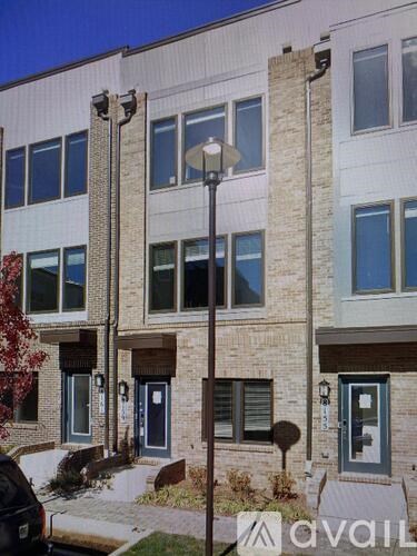 A building with a sign that says "avail" in front of it.