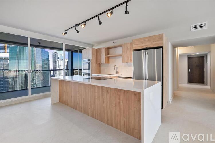 A modern kitchen with wooden cabinets and a large island.