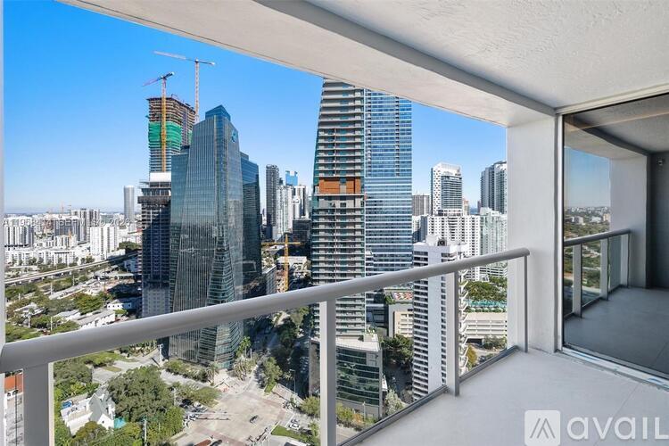 A balcony overlooks a cityscape with various buildings under construction.
