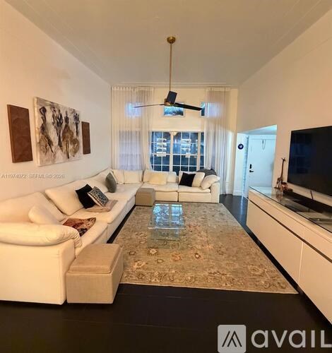 A living room with a white couch and a coffee table.