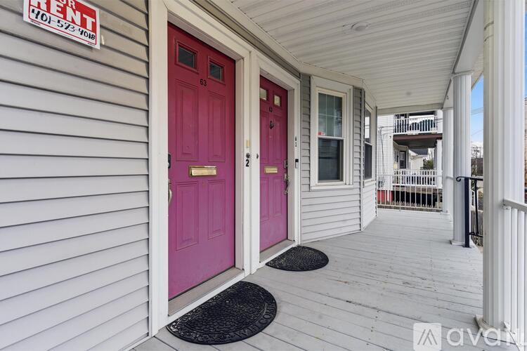 A house with a red door and a sign that says "For Rent".