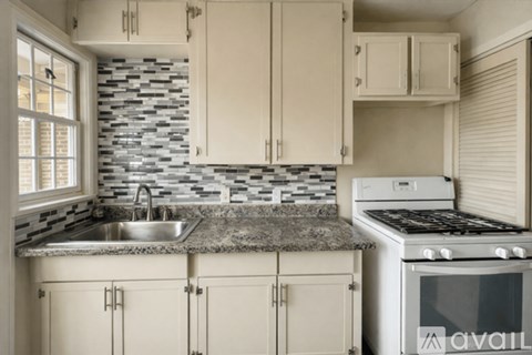 A kitchen with a stove and cabinets.