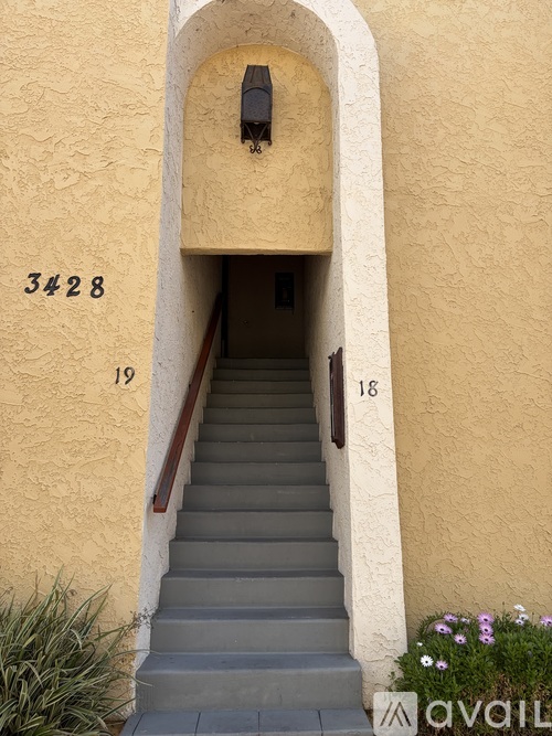 A staircase leads to a doorway with the number 3428 on the wall.