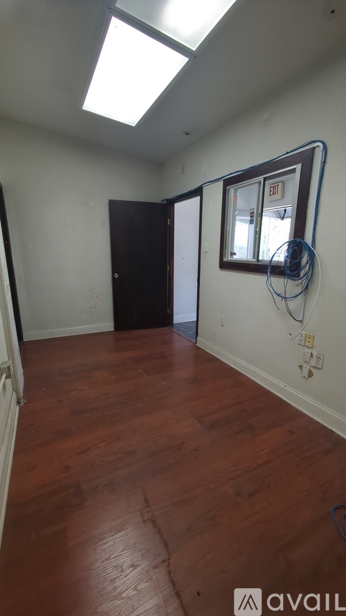 A room with wooden floors and a window.