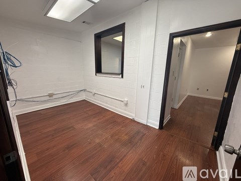A room with wooden floors and a window.