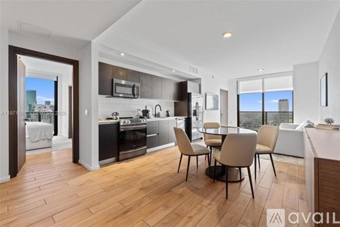 A modern kitchen with a dining table and chairs.