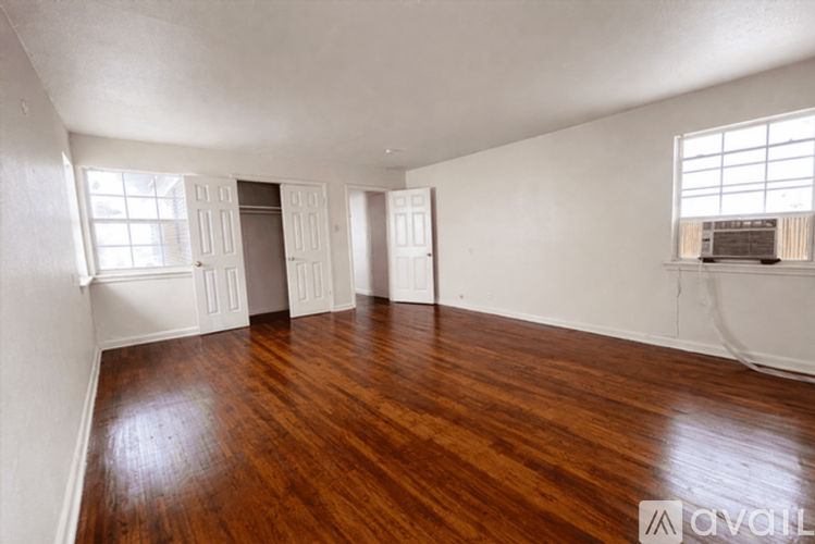 A room with wooden floors and white walls.