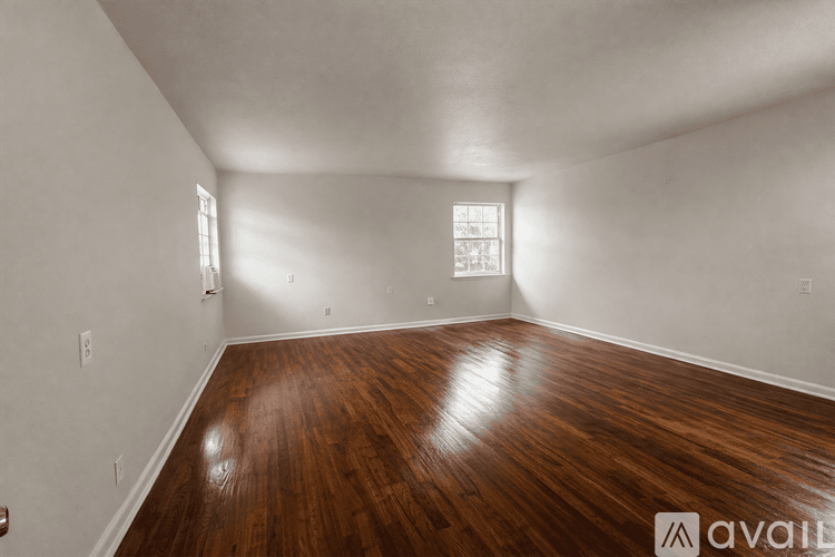 A room with wooden flooring and a window.