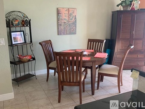 A dining room with a table set for four.