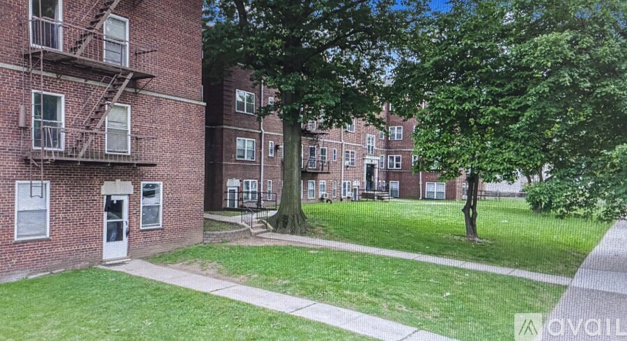 A brick building with a tree in front of it.