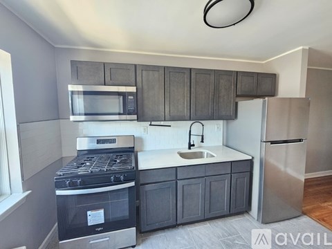 A kitchen with a stove, microwave, and refrigerator.