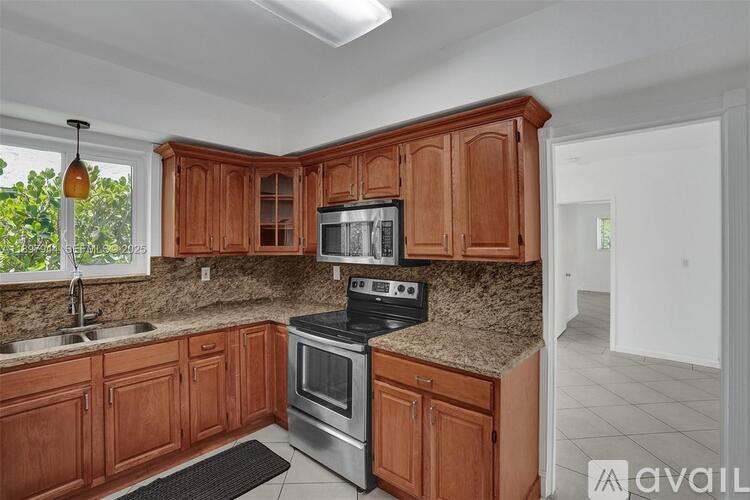 A kitchen with wooden cabinets and granite countertops.