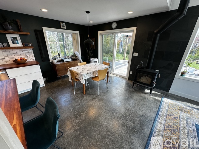 A black and white living room with a dining table and chairs.
