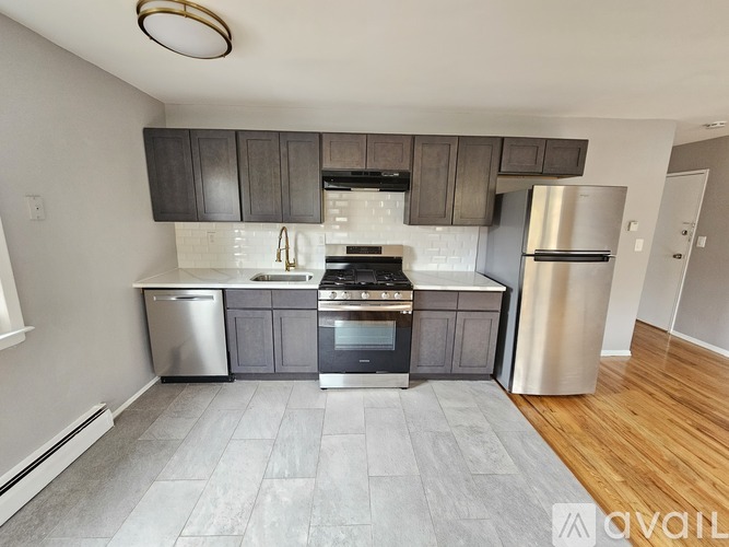A kitchen with a stainless steel refrigerator, dishwasher, oven, and microwave.