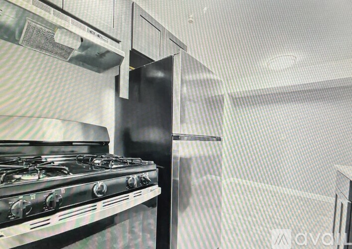 A stainless steel gas stove in a kitchen.