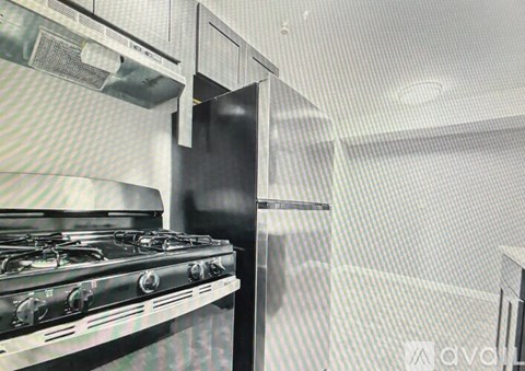 A stainless steel gas stove in a kitchen.