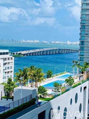 A view of a pool and a pier from a high-rise building.