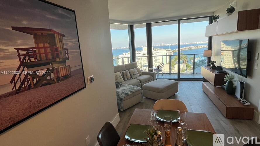 A living room with a view of the cityscape through the large windows.