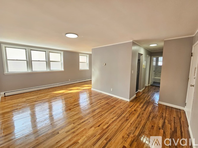 A room with wooden floors and a window.