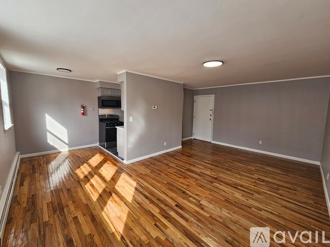 A room with wooden flooring and a white ceiling.