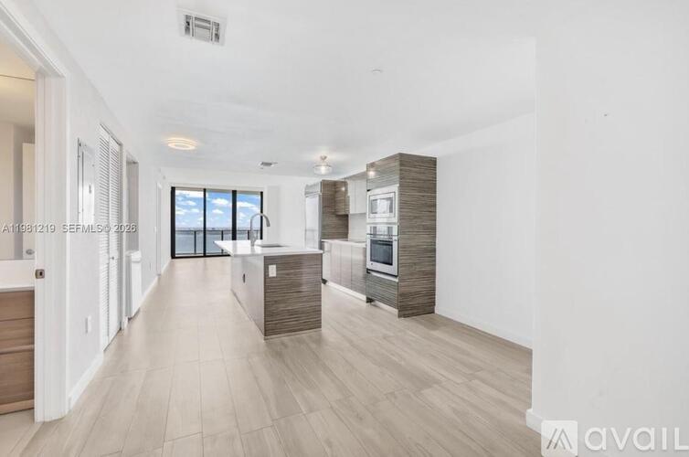 A spacious, modern kitchen with wooden cabinets and a large island.