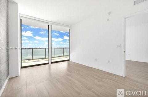 A spacious room with a view of the sky through the windows.