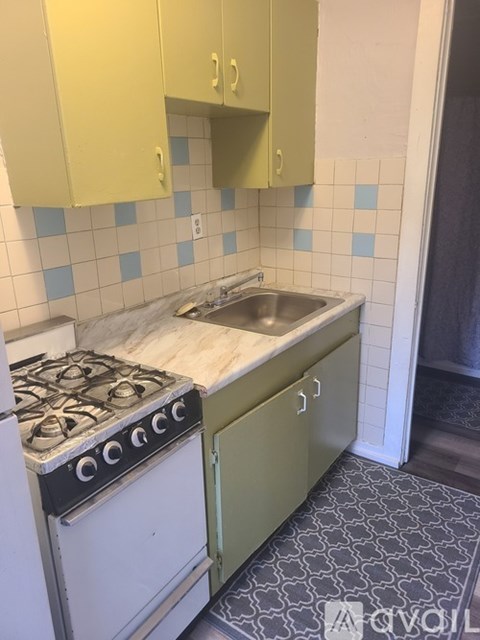 A kitchen with a stove and sink.