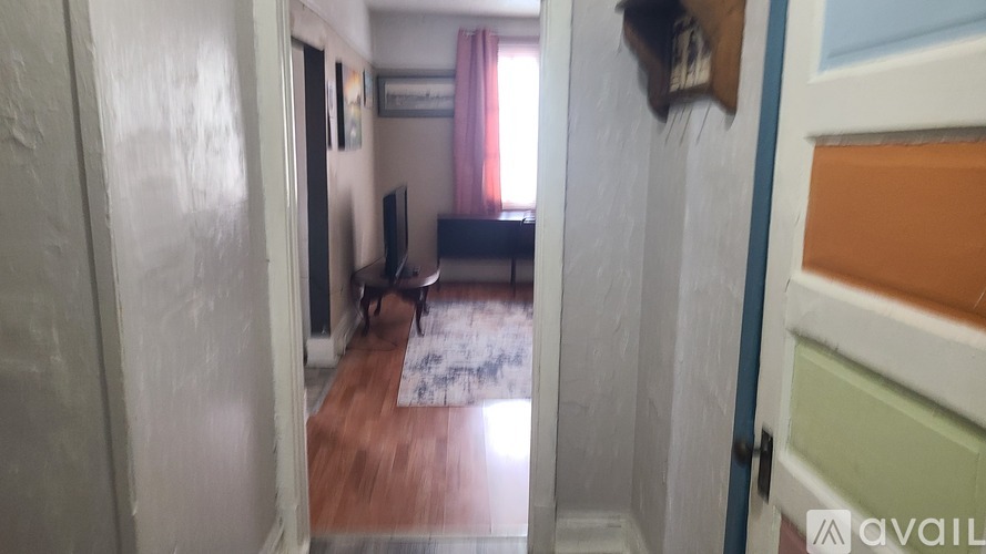 A room with a wooden floor and a sofa.