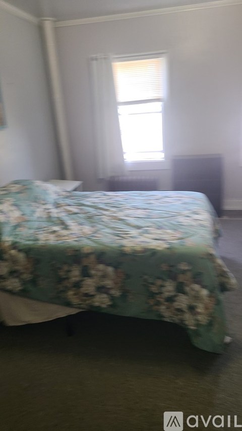 A room with a wooden floor and a sofa.