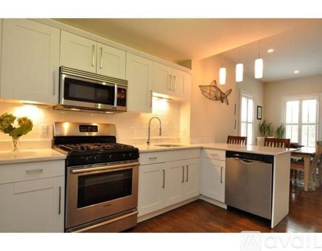 A kitchen with white cabinets and stainless steel appliances.