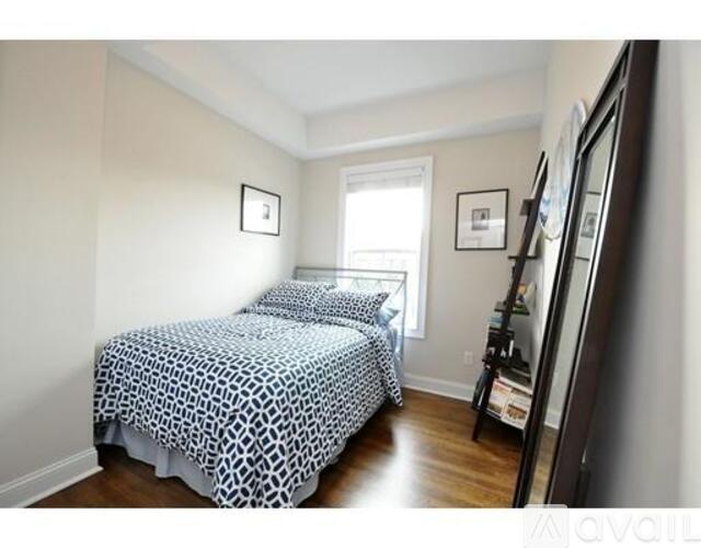 A bedroom with two beds and a dresser.