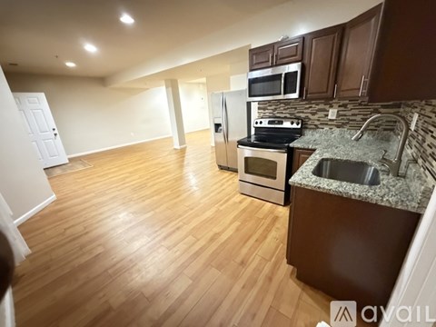 A kitchen with wooden floors and a counter top.