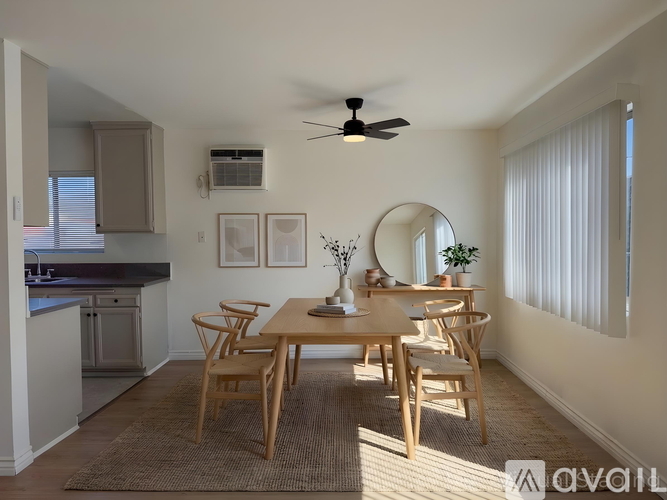 A dining room with a table and chairs.