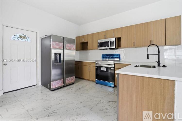 A kitchen with a white counter top and wooden cabinets.