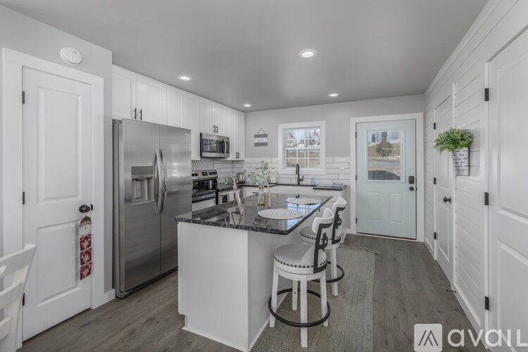 A modern kitchen with white cabinets and a central island.