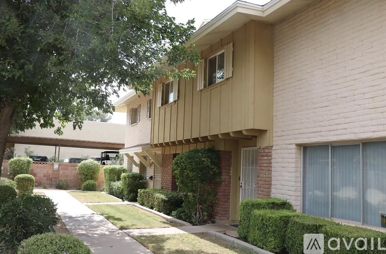 A house with a beige exterior and a white window is shown.