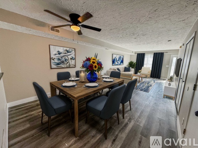 A dining room with a wooden table and chairs.