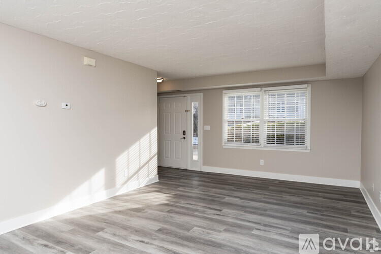 A spacious room with a door and a window.