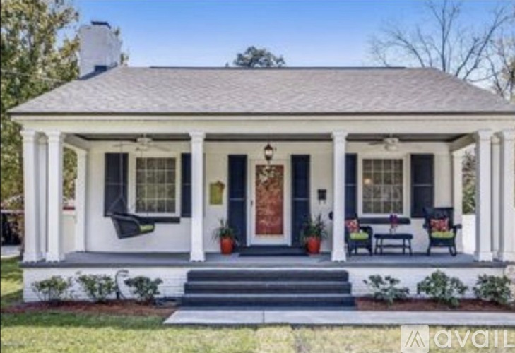 A white house with a blue door and windows.