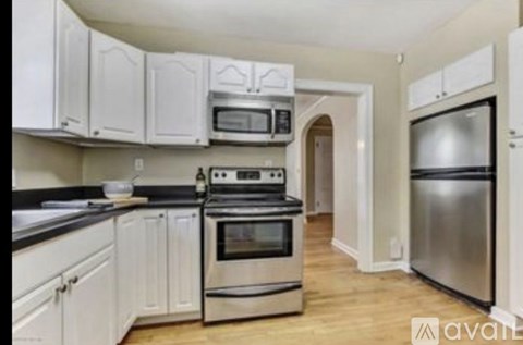 A kitchen with white cabinets and stainless steel appliances.