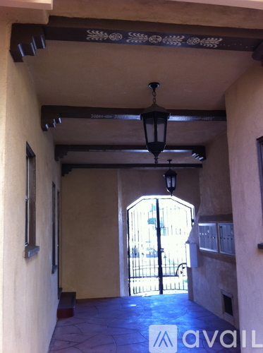 A hallway with a black lantern hanging from the ceiling.
