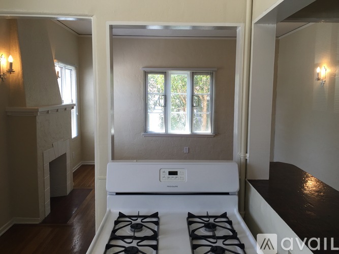 A white stove is in a room with a window.