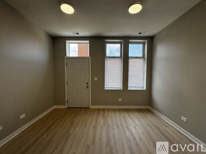 A room with a door and two windows.
