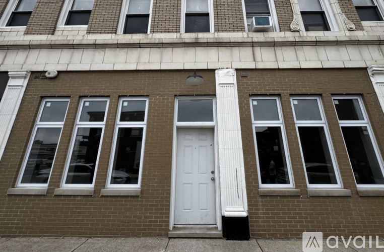 A building with a white door and windows with white frames.