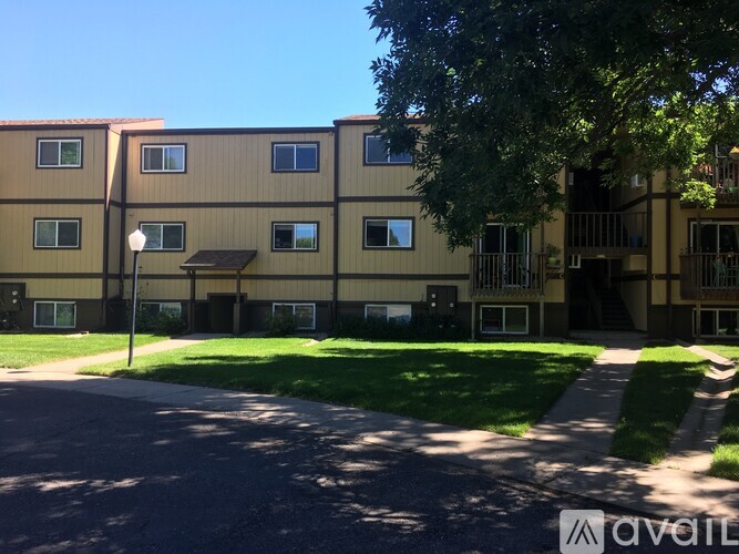 Apartment complex with a tree in front.