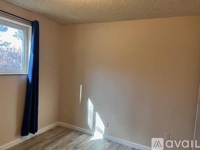 A room with a window and a wall with a cutout.