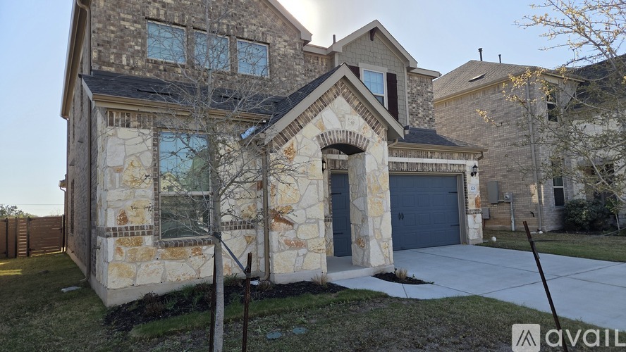 A house with a stone facade and a large front yard.