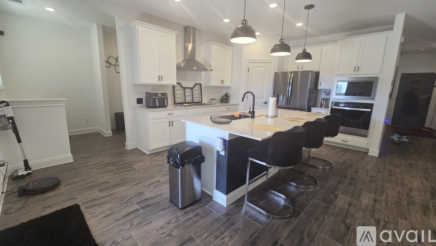 A modern kitchen with a dining table and chairs.