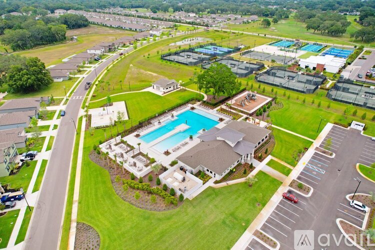 An aerial view of a residential area with a swimming pool and a parking lot.