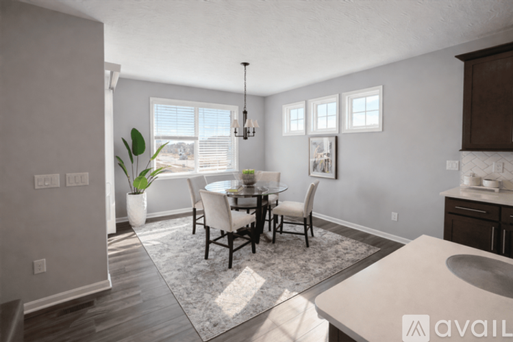 A dining room with a table set for four.